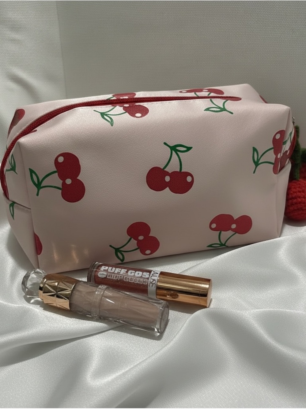 New silk cherry makeup bag with crochet charm and two Amuse lipgloss.